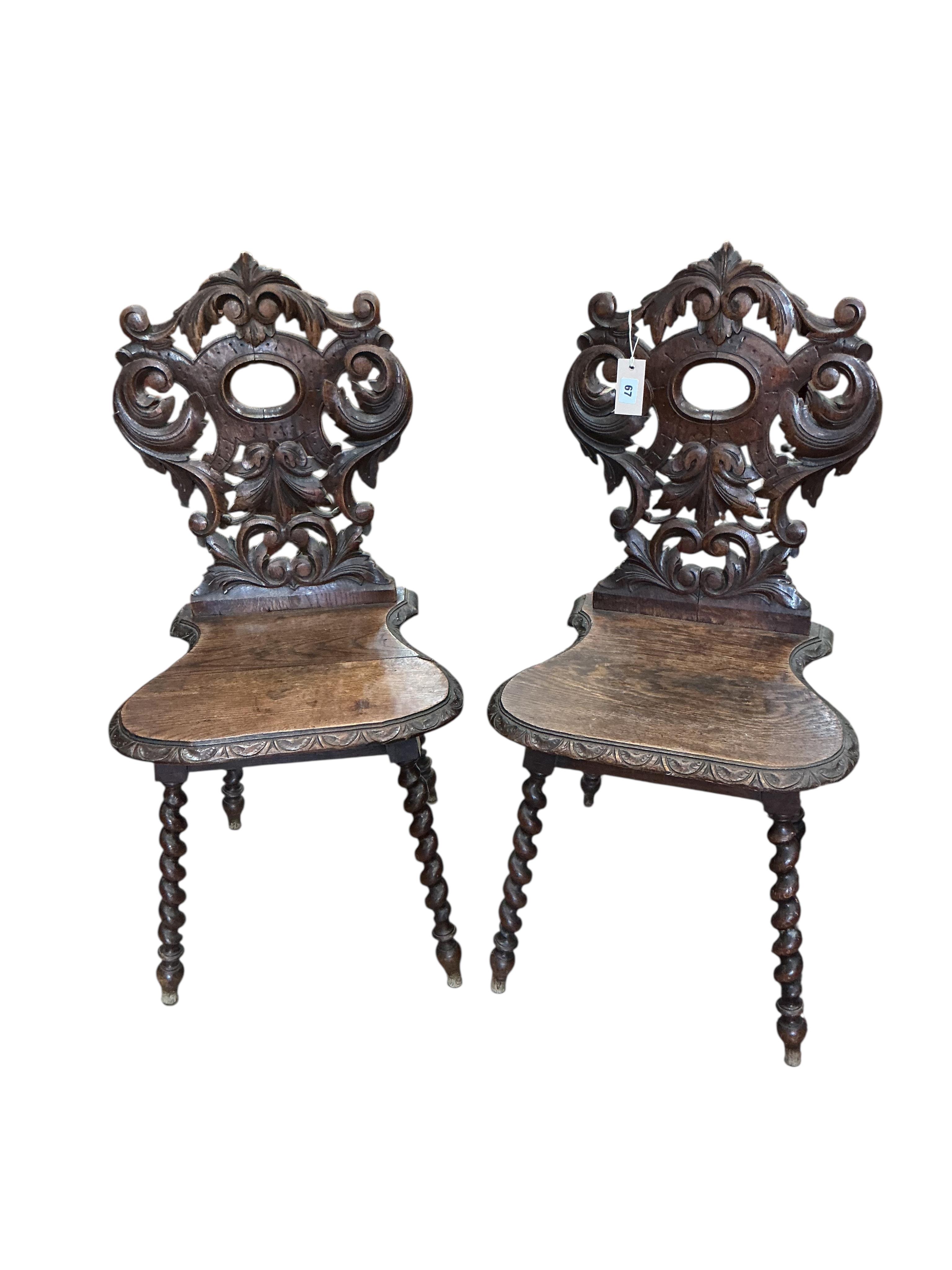 A pair of 19th century carved oak hall chairs, width 45cm, depth 34cm, height 94cm